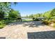 Expansive stone backyard patio with picturesque lake views and garden setting at 8655 Shoreline Dr, Jonesboro, GA 30236