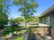 Scenic backyard with a charming fire pit, lush landscaping, and tranquil lake views, perfect for outdoor gatherings and relaxation at 8655 Shoreline Dr, Jonesboro, GA 30236