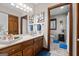 Cozy bathroom featuring a classic vanity, decorative wall art, and an adjacent toilet space at 8655 Shoreline Dr, Jonesboro, GA 30236