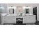 Bright bathroom featuring dual sinks, white cabinetry, and vanity with a modern design at 8655 Shoreline Dr, Jonesboro, GA 30236
