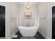 Bright bathroom featuring a freestanding tub, modern fixtures and a clean design at 8655 Shoreline Dr, Jonesboro, GA 30236