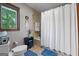 Well-lit bathroom with a shower/tub combo and decor, creating a welcoming and functional space at 8655 Shoreline Dr, Jonesboro, GA 30236