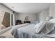 Well-lit bedroom featuring a queen bed, dresser, large window, and comfortable chair near a crib at 8655 Shoreline Dr, Jonesboro, GA 30236