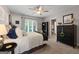 Comfortable bedroom with neutral tones, a ceiling fan, and large window offering natural light at 8655 Shoreline Dr, Jonesboro, GA 30236