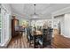 Elegant dining room with tray ceiling, hardwood floors, and an open view into the kitchen at 8655 Shoreline Dr, Jonesboro, GA 30236