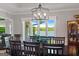 Dining room with beautiful lighting fixture and water views visible through a set of windows at 8655 Shoreline Dr, Jonesboro, GA 30236