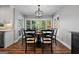 Beautiful dining room with large bay windows with serene outside views and stylish chandelier at 8655 Shoreline Dr, Jonesboro, GA 30236
