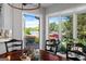 The dining room offers stunning lake views and access to the outdoor deck and patio at 8655 Shoreline Dr, Jonesboro, GA 30236
