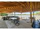 Inviting covered dock with dining area, outdoor kitchen, boat slip and lake views, perfect for entertaining and enjoying waterfront living at 8655 Shoreline Dr, Jonesboro, GA 30236