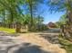 Gated driveway with stone pillars and mature trees, providing security and privacy to this well-manicured estate at 8655 Shoreline Dr, Jonesboro, GA 30236
