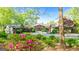 Charming home showcasing lush landscaping, creating a warm and inviting atmosphere, surrounded by mature trees at 8655 Shoreline Dr, Jonesboro, GA 30236