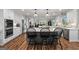 Open concept kitchen with stainless appliances, marble island with pendant lights and eat-in bar at 8655 Shoreline Dr, Jonesboro, GA 30236