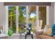 Bright living room featuring a large window with a view of the lake, comfortable seating and neutral decor at 8655 Shoreline Dr, Jonesboro, GA 30236