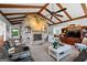 Spacious living room with stone fireplace, exposed wooden beams, and ample seating at 8655 Shoreline Dr, Jonesboro, GA 30236