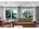 Cozy living room featuring a comfortable sofa and sliding glass doors with a scenic lake view at 8655 Shoreline Dr, Jonesboro, GA 30236