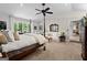 Bright and airy main bedroom features a four-poster bed, sitting area and scenic views at 8655 Shoreline Dr, Jonesboro, GA 30236