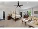 Spacious main bedroom features a four-poster bed, sitting area, ceiling fan and lots of natural light at 8655 Shoreline Dr, Jonesboro, GA 30236