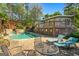 Inviting backyard pool area with stone accents, patio furniture, and a raised deck perfect for relaxing at 8655 Shoreline Dr, Jonesboro, GA 30236