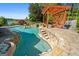 A picturesque pool with stone steps and a pergola, creating a serene backyard retreat for swimming and relaxation at 8655 Shoreline Dr, Jonesboro, GA 30236