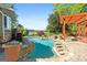 Lakeside pool with stone accents and a pergola, creating a relaxing backyard retreat for outdoor enjoyment at 8655 Shoreline Dr, Jonesboro, GA 30236