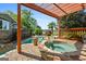 Backyard oasis with a pool, spa, and a pergola-covered seating area perfect for outdoor entertaining at 8655 Shoreline Dr, Jonesboro, GA 30236