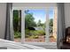 Picturesque window view of the lake showing lush landscaping around a charming lakeside home at 8655 Shoreline Dr, Jonesboro, GA 30236