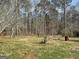Overgrown backyard with a firepit area at 2467 Highway 138 Sw, Conyers, GA 30094