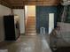 Basement with refrigerator, stairs, and concrete floors for storage and projects at 2467 Highway 138 Sw, Conyers, GA 30094