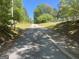 Driveway leading up to the house through a wooded landscape at 2467 Highway 138 Sw, Conyers, GA 30094