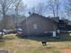 Exterior side view of a brown home with a black cat in the yard at 2467 Highway 138 Sw, Conyers, GA 30094