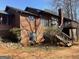 Rear exterior of home featuring a second-story deck, wood siding, and brick foundation at 2467 Highway 138 Sw, Conyers, GA 30094