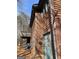 Back exterior shot of the home with a deck, wooden siding, brick foundation, and a walkout door at 2467 Highway 138 Sw, Conyers, GA 30094
