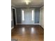 Foyer with hardwood floors, light-colored walls, and a white front door with glass inserts at 2467 Highway 138 Sw, Conyers, GA 30094