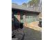 A green garage with a side door and space for parking at 2467 Highway 138 Sw, Conyers, GA 30094