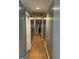 Neutral hallway with hardwood floors and crown molding details offering classic charm at 2467 Highway 138 Sw, Conyers, GA 30094