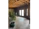Unfinished living room with wood-burning stove, exposed ceiling joists, and a sliding glass door to the exterior at 2467 Highway 138 Sw, Conyers, GA 30094