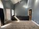 Living room featuring carpet, vaulted ceiling, and natural light from a window at 2467 Highway 138 Sw, Conyers, GA 30094