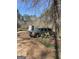 Shows vehicle and trees in this property at 2467 Highway 138 Sw, Conyers, GA 30094