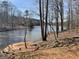 Scenic view of a lake with a wooden dock, surrounded by trees in a peaceful setting at 2467 Highway 138 Sw, Conyers, GA 30094