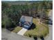 Aerial shot of a two-story home with a long driveway, surrounded by lush trees and greenery at 101 Greenfield Ln, Grantville, GA 30220