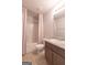 Upstairs bathroom featuring shower and tub combination, granite top vanity and grey cabinets at 101 Greenfield Ln, Grantville, GA 30220