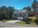 Charming two-story home with a manicured lawn, two-car garage, and a mix of stone and siding finishes at 101 Greenfield Ln, Grantville, GA 30220