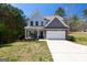 Two-story home with a two-car garage, stone accents, and a well-maintained lawn at 101 Greenfield Ln, Grantville, GA 30220