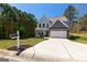 Charming two-story home with stone accents, a well-manicured lawn, and mature trees at 101 Greenfield Ln, Grantville, GA 30220