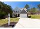 Charming two-story home with a well-manicured front lawn and a spacious driveway at 101 Greenfield Ln, Grantville, GA 30220