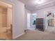 Spacious upstairs hallway featuring three doors, carpeted floors and a dresser at 101 Greenfield Ln, Grantville, GA 30220
