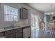 Kitchen with stainless appliances and granite counters flows to the dining and outdoor spaces at 101 Greenfield Ln, Grantville, GA 30220