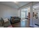 Open-concept living room with neutral walls, hardwood floors, and ample natural light at 101 Greenfield Ln, Grantville, GA 30220