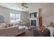 Living room features a fireplace, ceiling fan, hardwood floors and a large window at 101 Greenfield Ln, Grantville, GA 30220