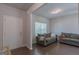 Bright living room with dark floors, grey sofas, and a large window providing natural light at 101 Greenfield Ln, Grantville, GA 30220